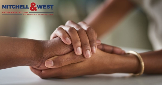 two individuals holding hands in support